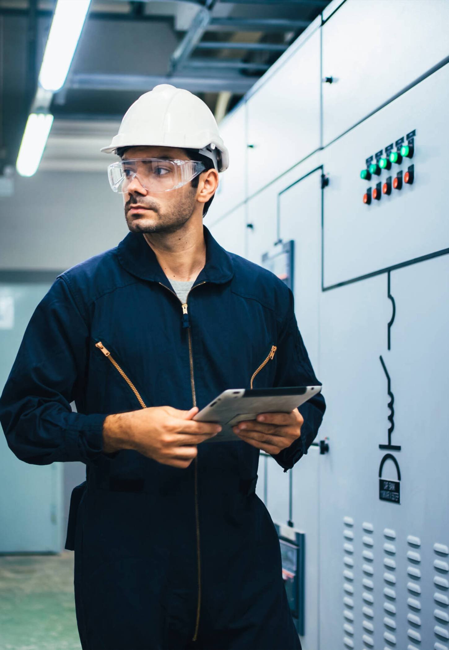 Smart Electrician engineer technician using tablet controlling machine and working at industrial plant factory